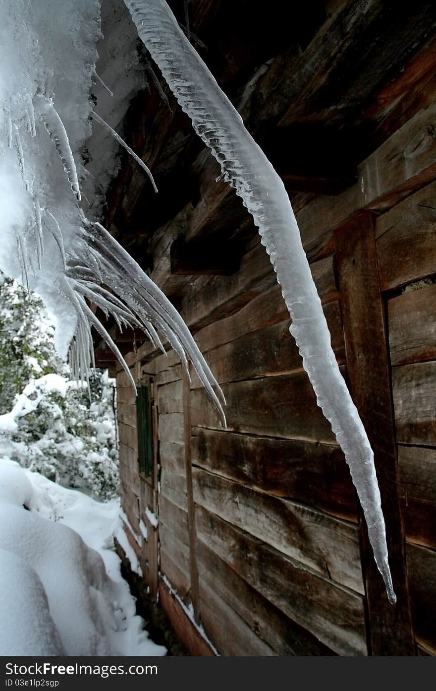 Icicles on a roof in a frozen winter day