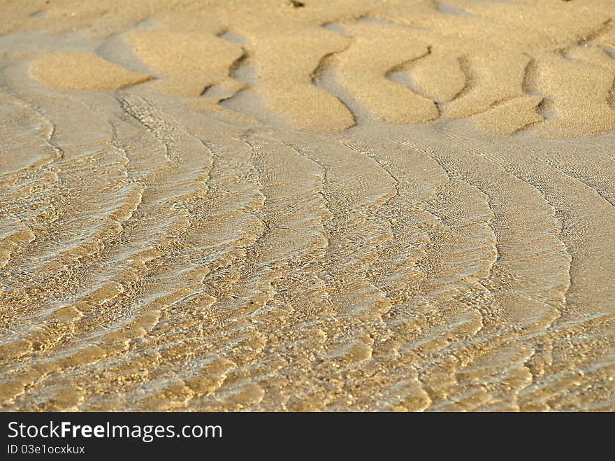 Waves in the sun. The waves on the reflection of sunlight in a shallow sandy sea. Waves in the sun. The waves on the reflection of sunlight in a shallow sandy sea.