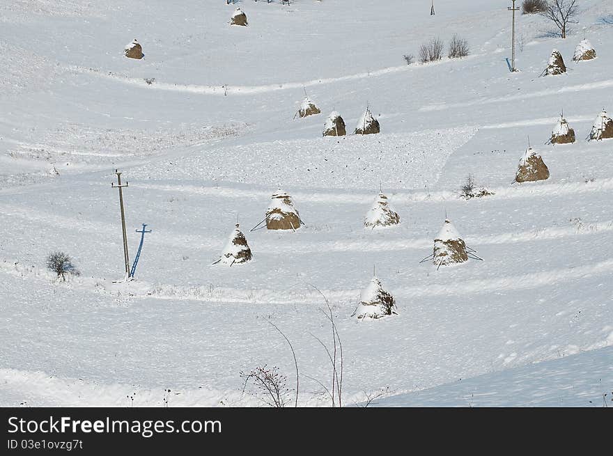 Haystacks in the mountains of bright frosty winter day. Haystacks in the mountains of bright frosty winter day