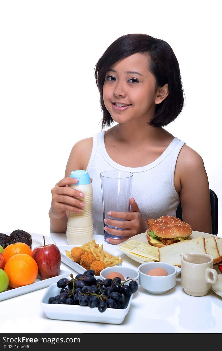 An attractive Asian woman eating a healthy breakfast