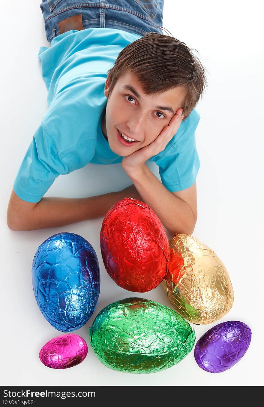 Boy with a bunch of chocolate easter eggs