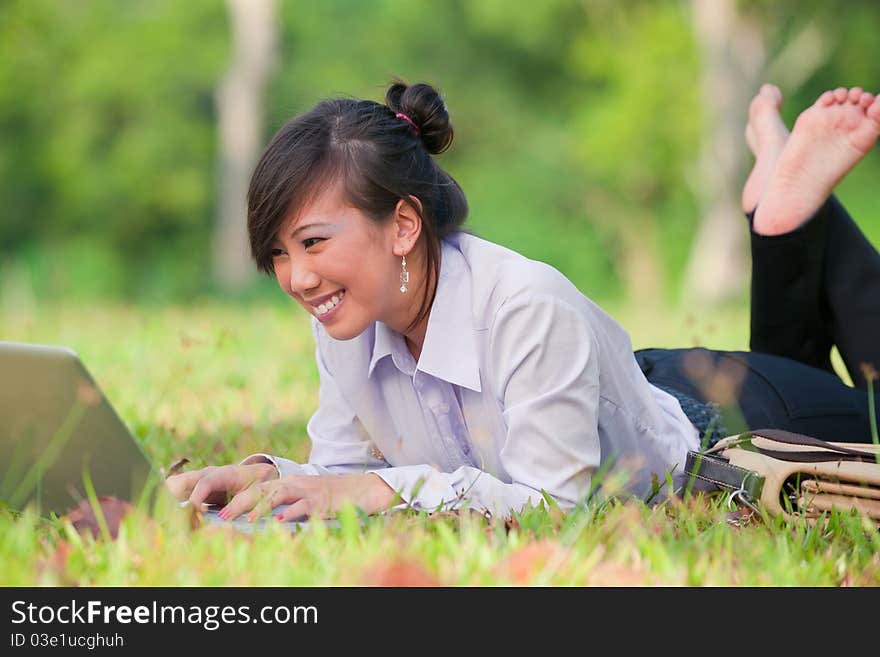 Business woman staying connected while out in the park. Business woman staying connected while out in the park