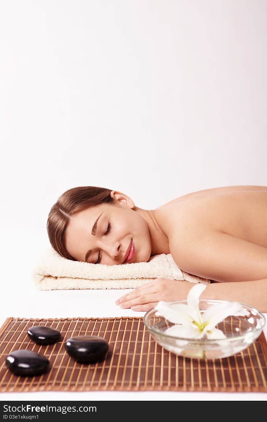 Young naked girl in a spa on a white background. Young naked girl in a spa on a white background