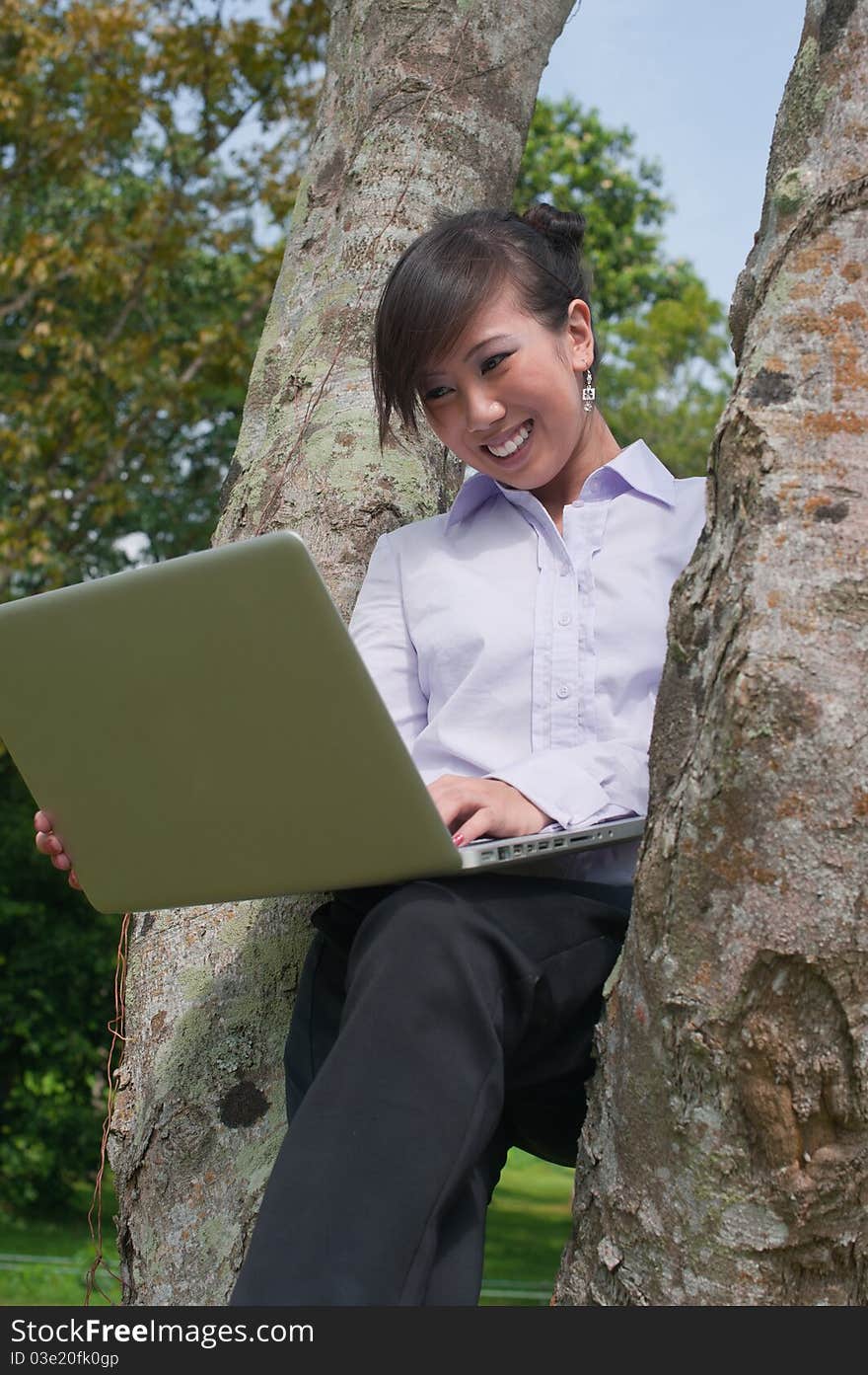 Business woman staying connected while out in the park. Business woman staying connected while out in the park