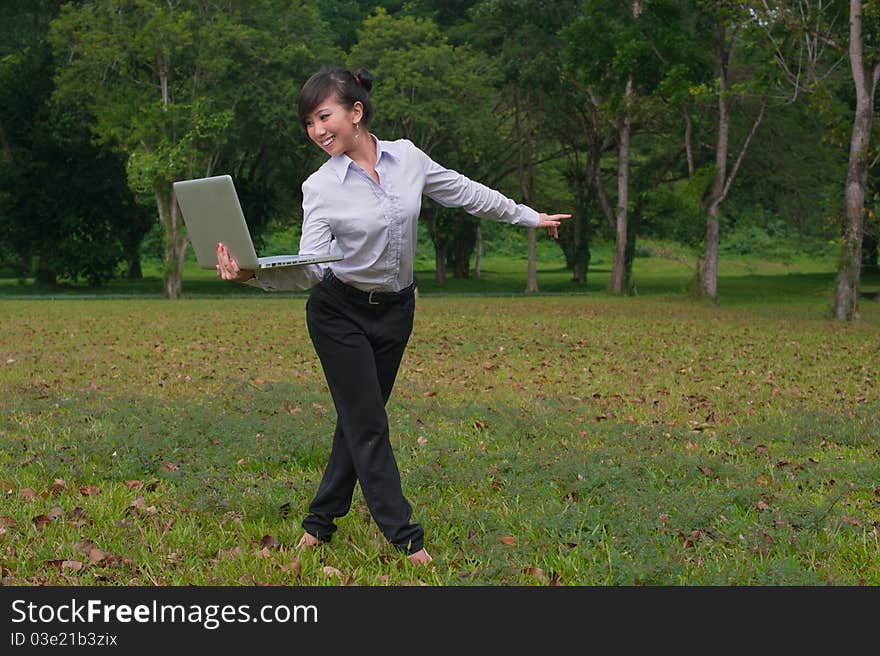 Business woman staying connected while out in the park. Business woman staying connected while out in the park