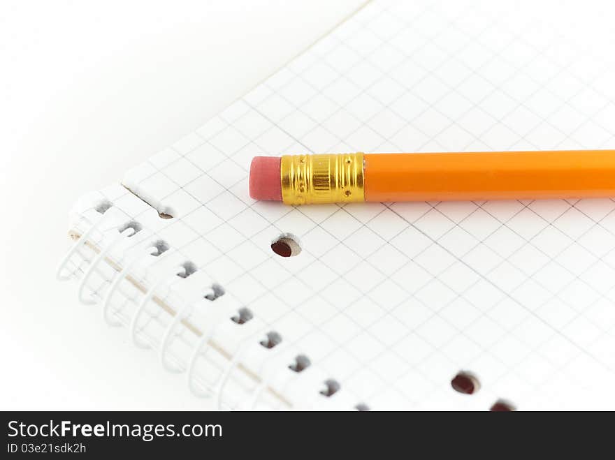 Notepad with a orange pencil