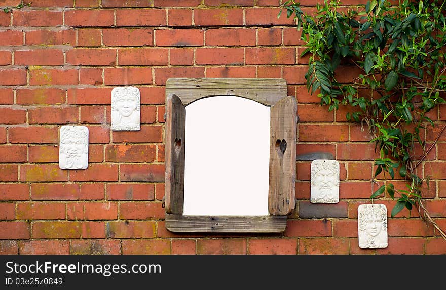 A hanging window on an old garden wall with space for your own image. A hanging window on an old garden wall with space for your own image