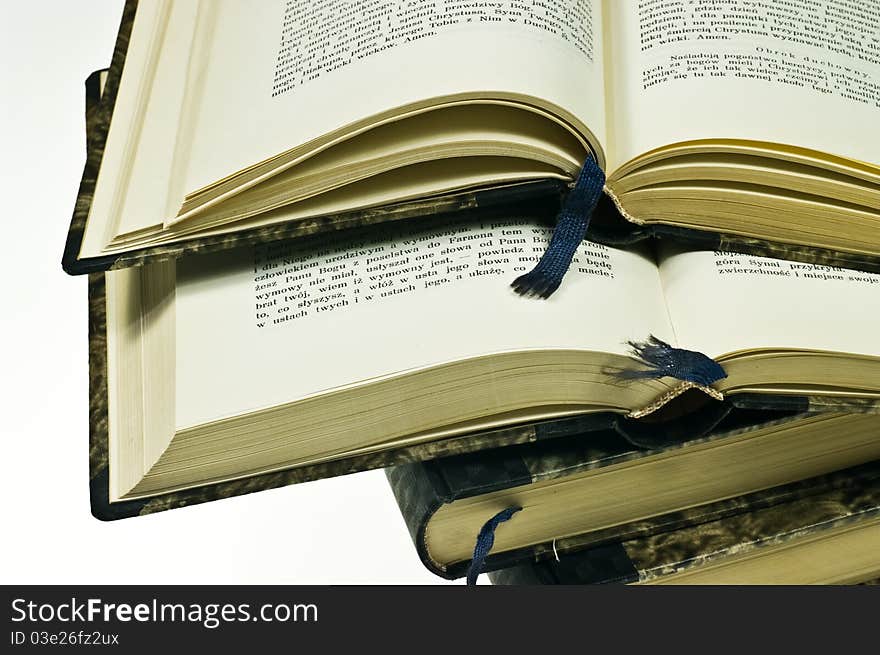 Stack of old books on white