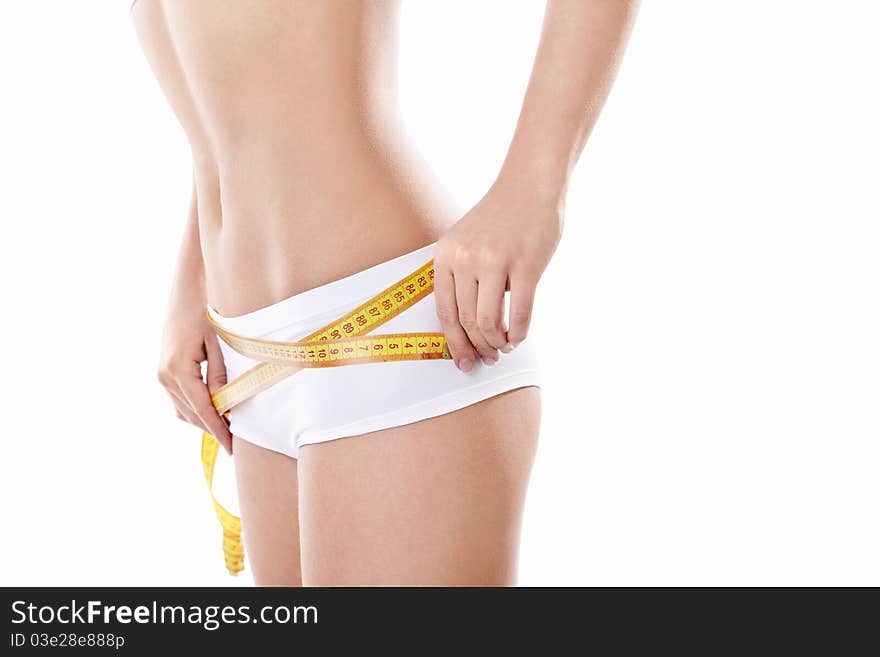 Young girl measuring hip on a white background. Young girl measuring hip on a white background