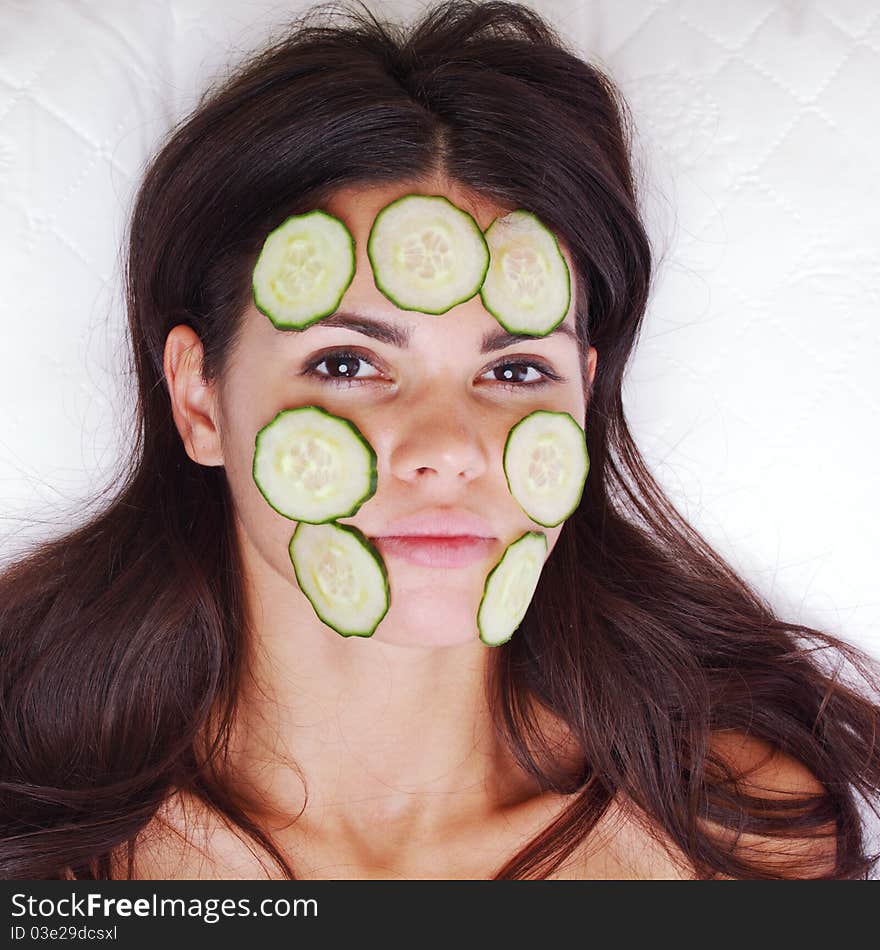 Cucumbers circles on a girl face. Cucumbers circles on a girl face