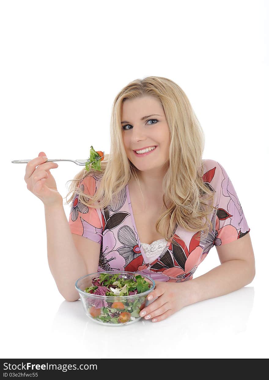 Beautiful woman eating green vegetable salad.