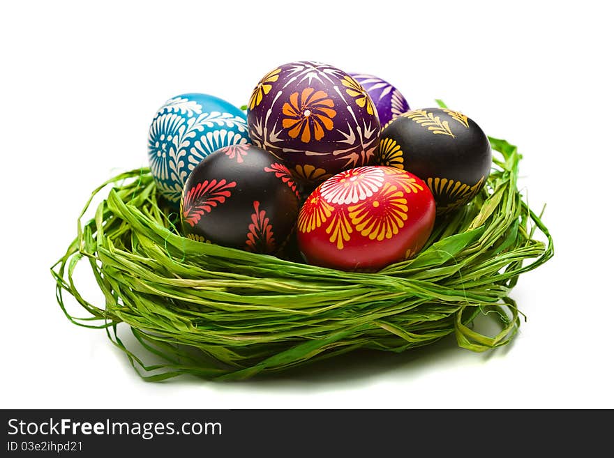 Painted easter eggs in basket on white background. Painted easter eggs in basket on white background