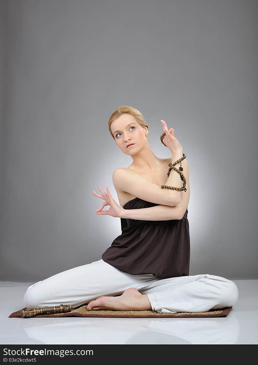 Creative portrait of young woman in yoga relaxation pose. Creative portrait of young woman in yoga relaxation pose