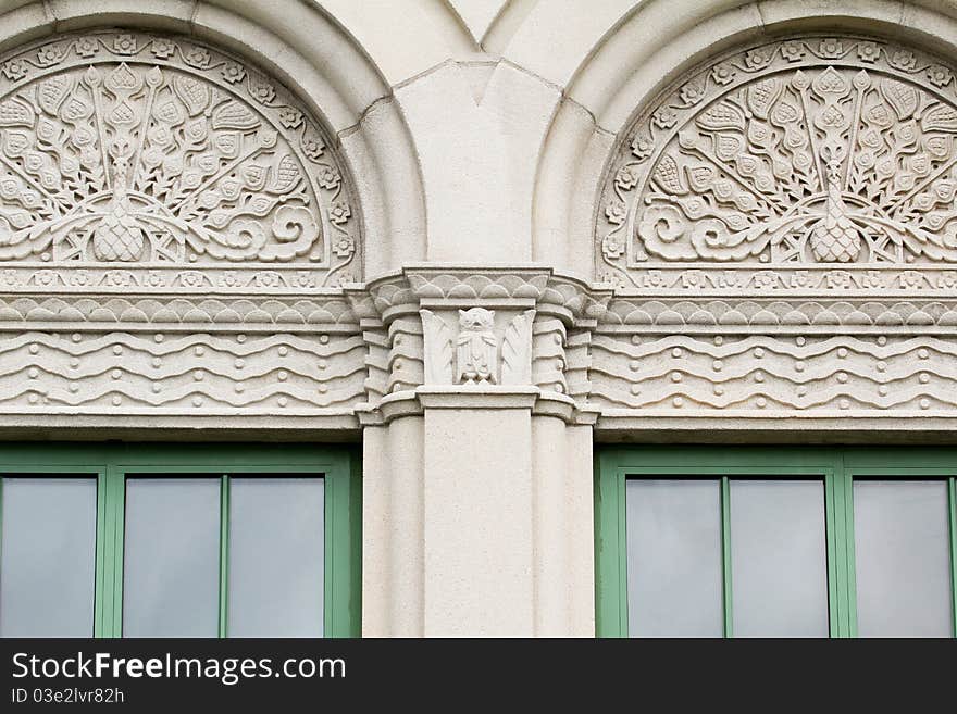 Stone and cement peacock design and owl frieze around windows. Stone and cement peacock design and owl frieze around windows