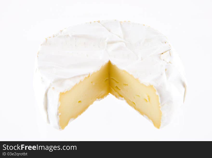 A pice of french cheese on a white background