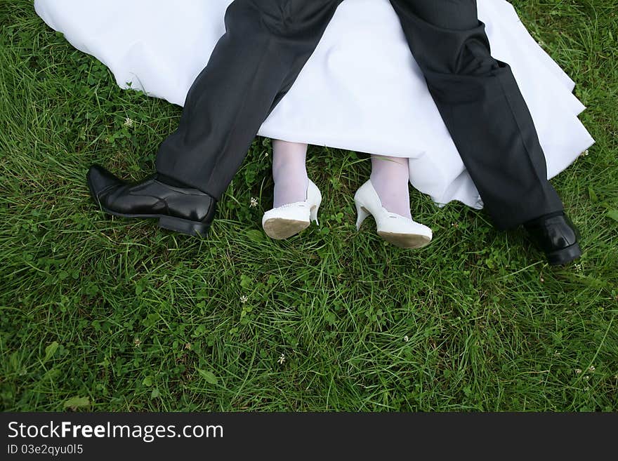 Wedding newlyweds walk ended with kisses on the grass