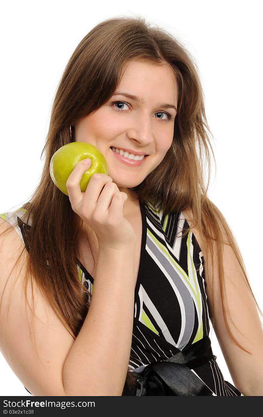 Portrait of cheerful young woman holding a  green apple and smiling isolated against white background