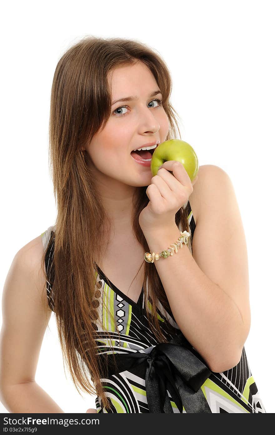 Portrait of cheerful young woman holding a  green apple and smiling isolated against white background