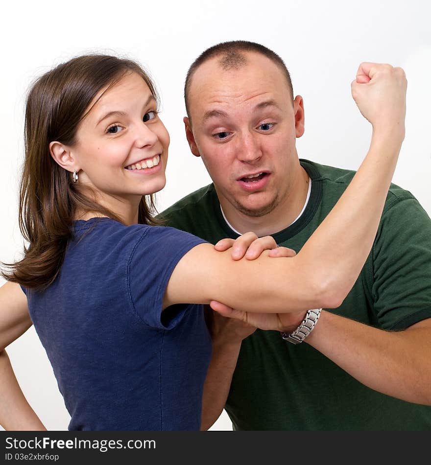 Husband checking out his wife's muscles in surprise at how big they are. Husband checking out his wife's muscles in surprise at how big they are.