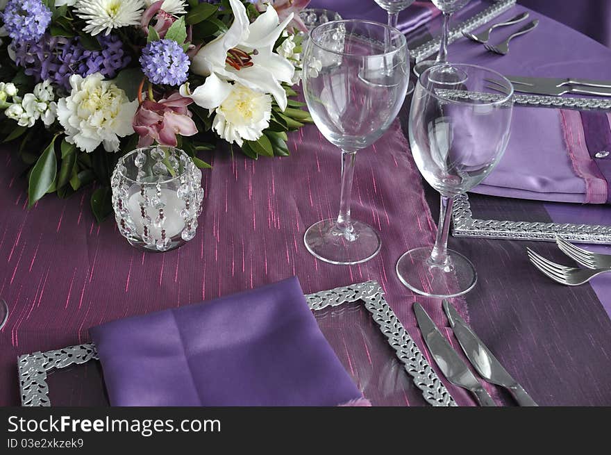 Flowers and wine glasses on the party table of wedding ceremony. Flowers and wine glasses on the party table of wedding ceremony