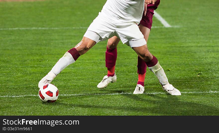 Soccer players fighting for the ball