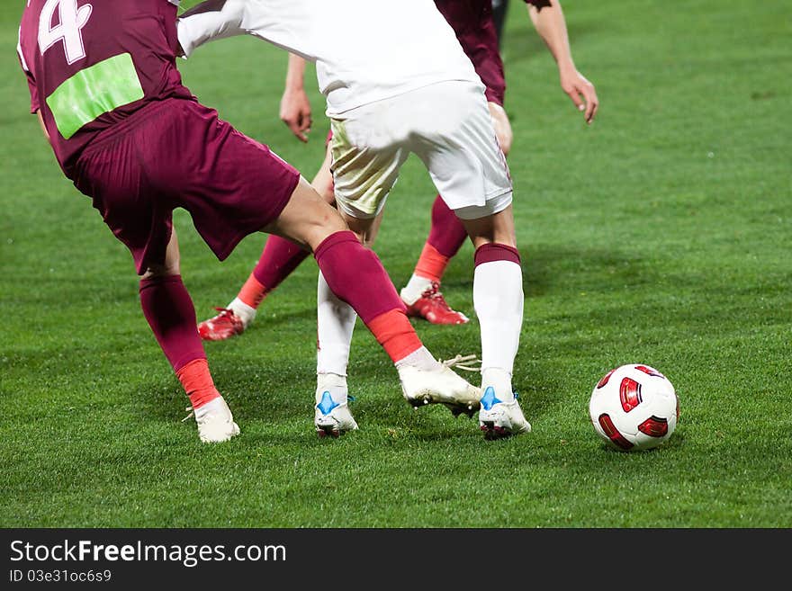 Soccer players fighting for the ball