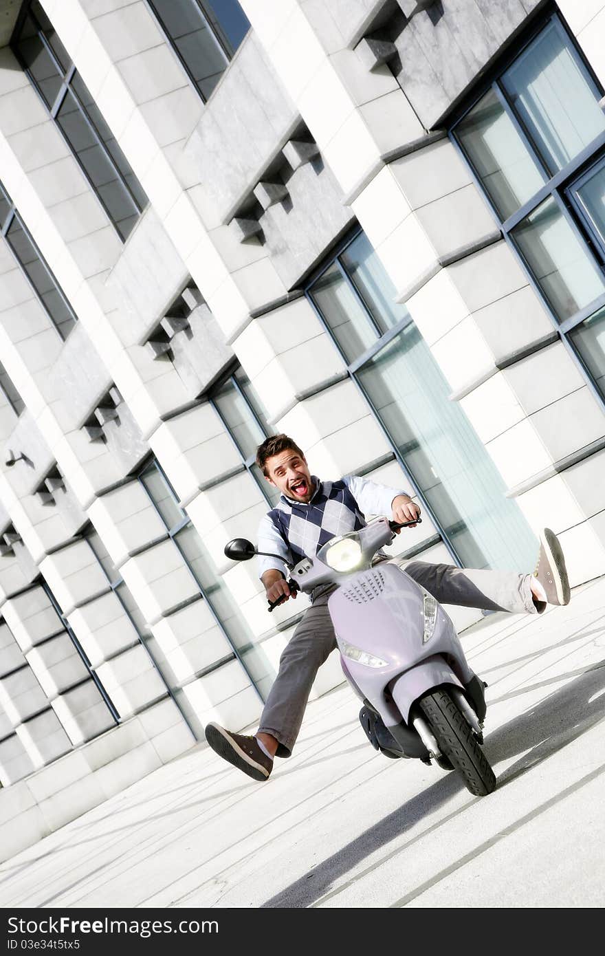 Young happy man on scooter