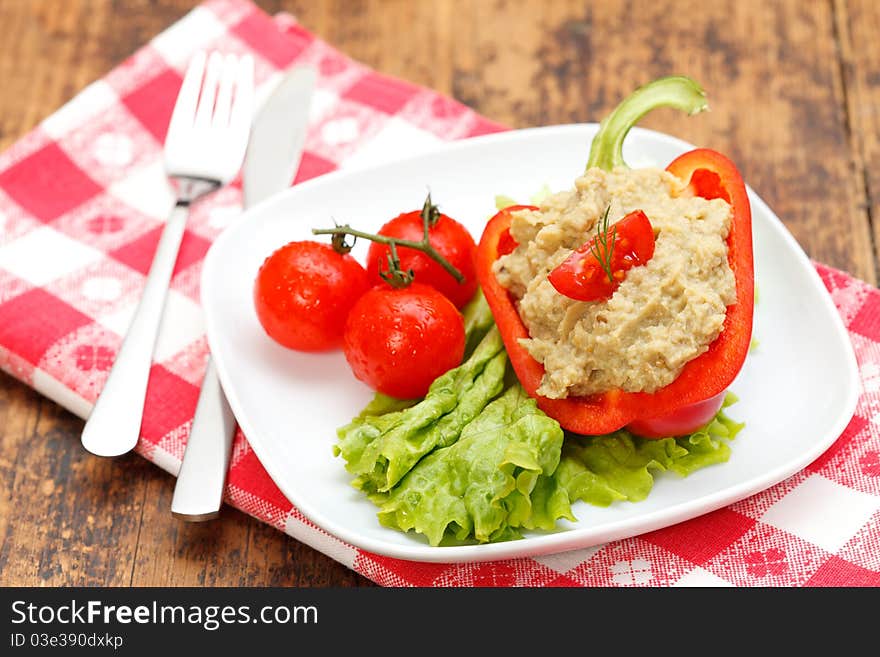 Tasty eggplant salad with fresh vegetables on a plate