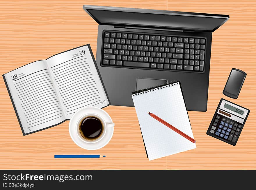 Laptop and office supplies laying on the table