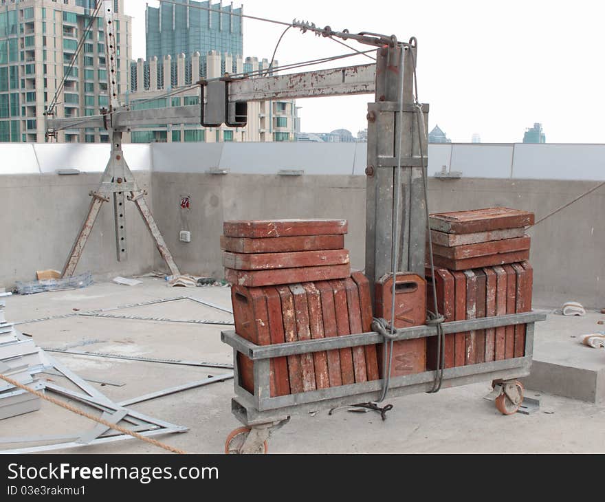 Counter weight of a construction crane on top of a high-rise building. Counter weight of a construction crane on top of a high-rise building