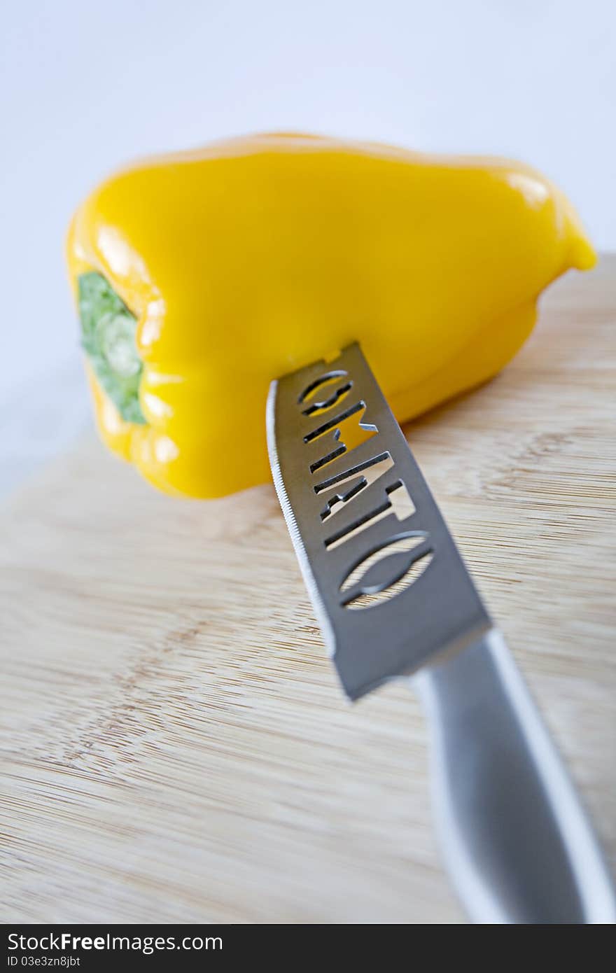 Sweet yellow pepper with a knife