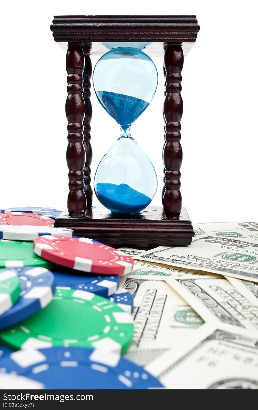 Hourglass and poker chips isolated on a white background