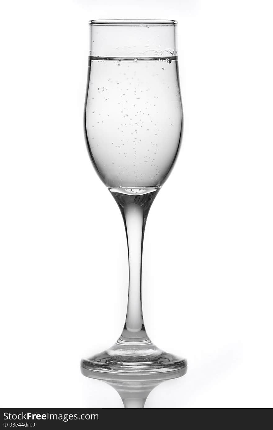 Glass with mineral water isolated on a white background