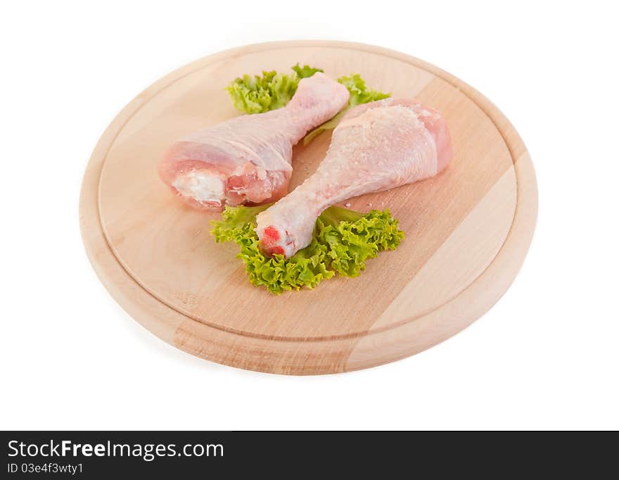 Fresh raw chicken legs on wooden board