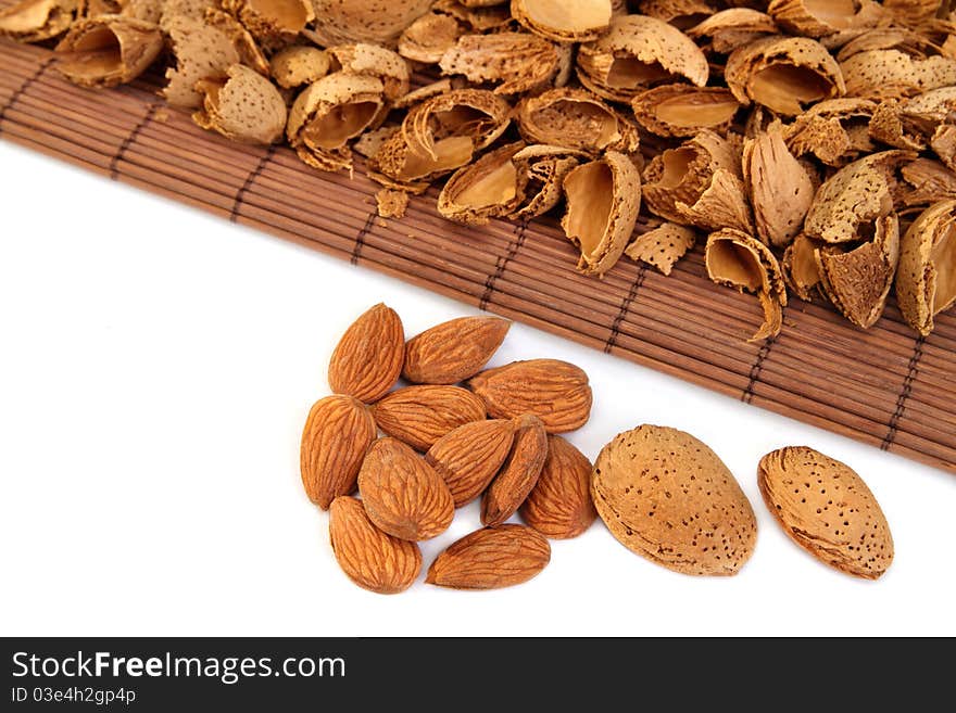 Almond nuts and kernels with hulls on white background. Almond nuts and kernels with hulls on white background