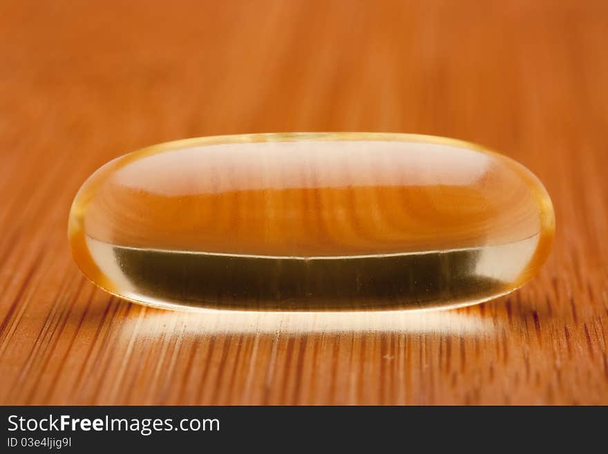 Medical pill against diseases on a wooden table.