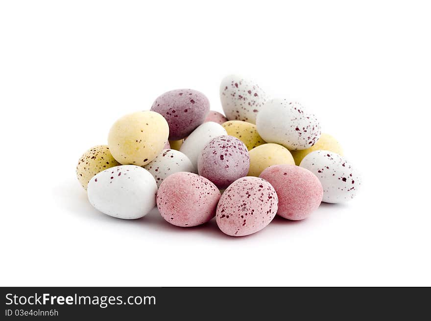 Pile of chocolate easter eggs over white