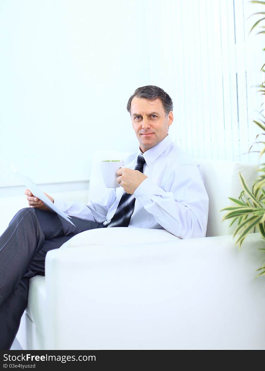 Entrepreneur working from home looking very relaxed in his sofa browsing the web in his laptop computer