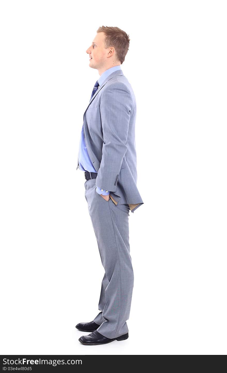 Full length of a handsome business man with hands folded against white background