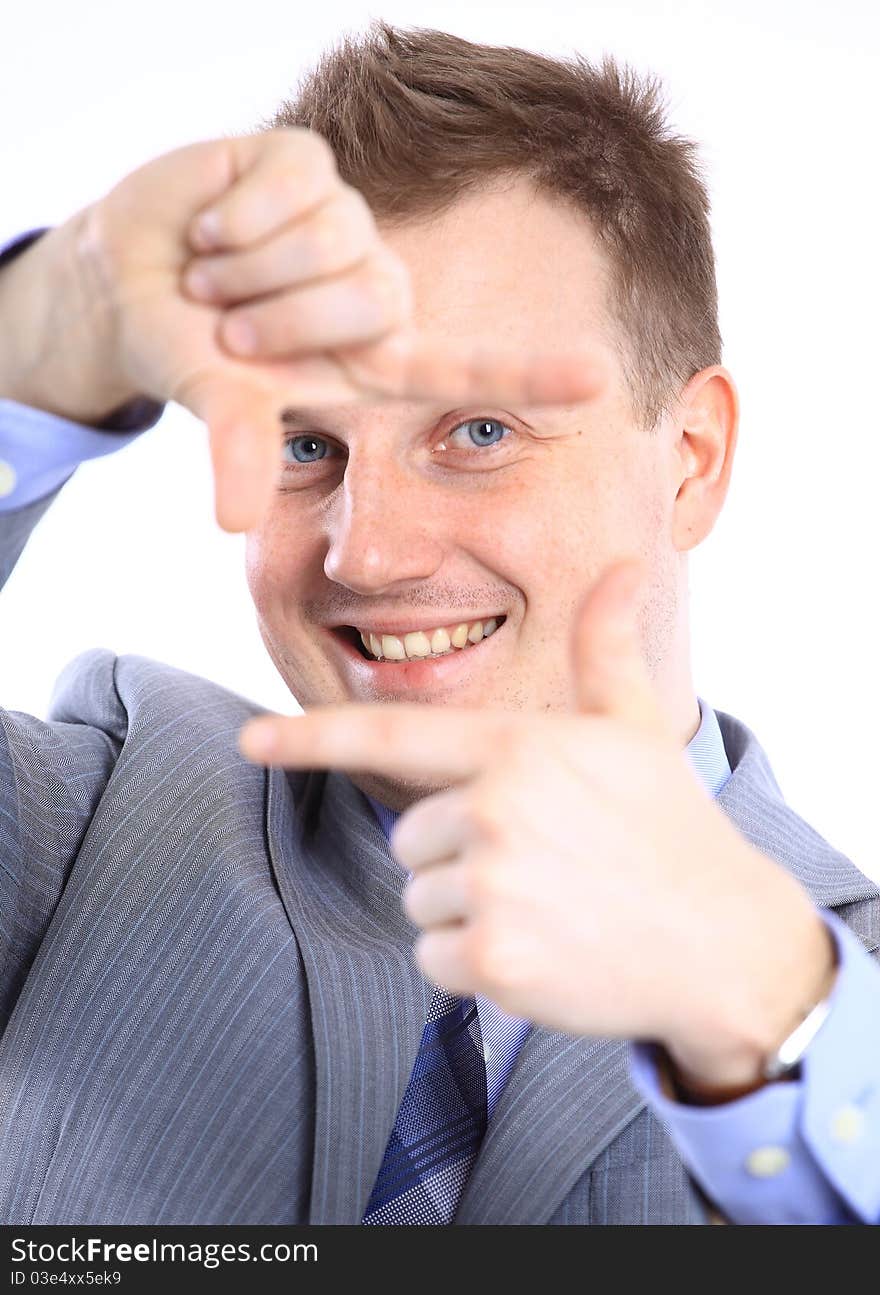 Full length of a handsome business man with hands folded against white background