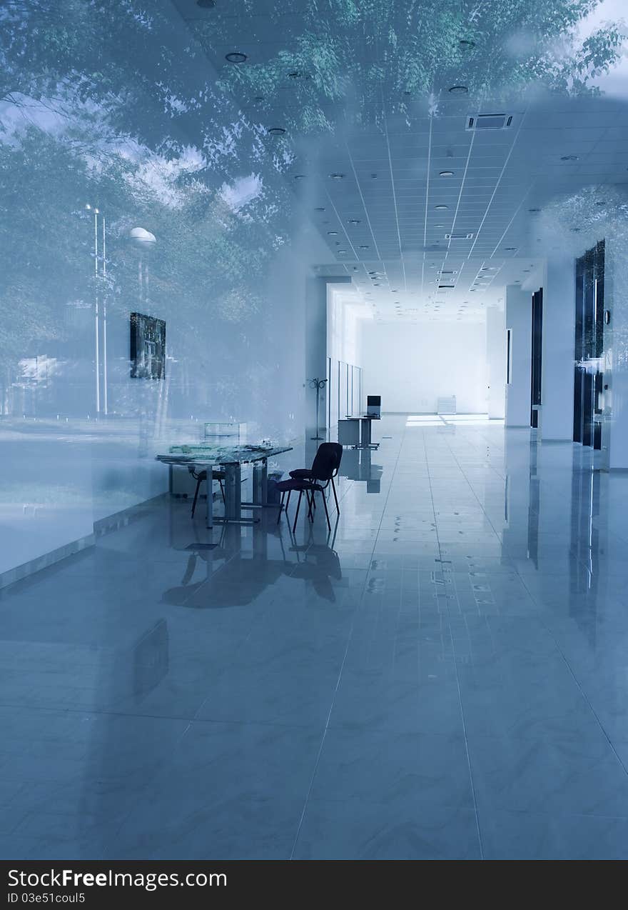 Modern office interior in a bluish tone with reflections of an outter objects. Modern office interior in a bluish tone with reflections of an outter objects