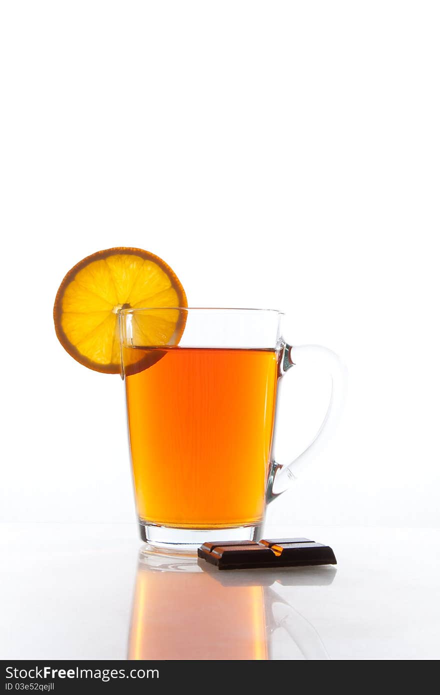 Transparent tea cup with orange slice and chocolate. Transparent tea cup with orange slice and chocolate