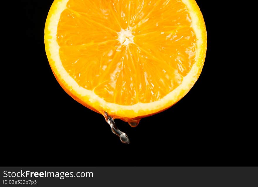 Vivid oranges slices on black bakground with water drop. Vivid oranges slices on black bakground with water drop