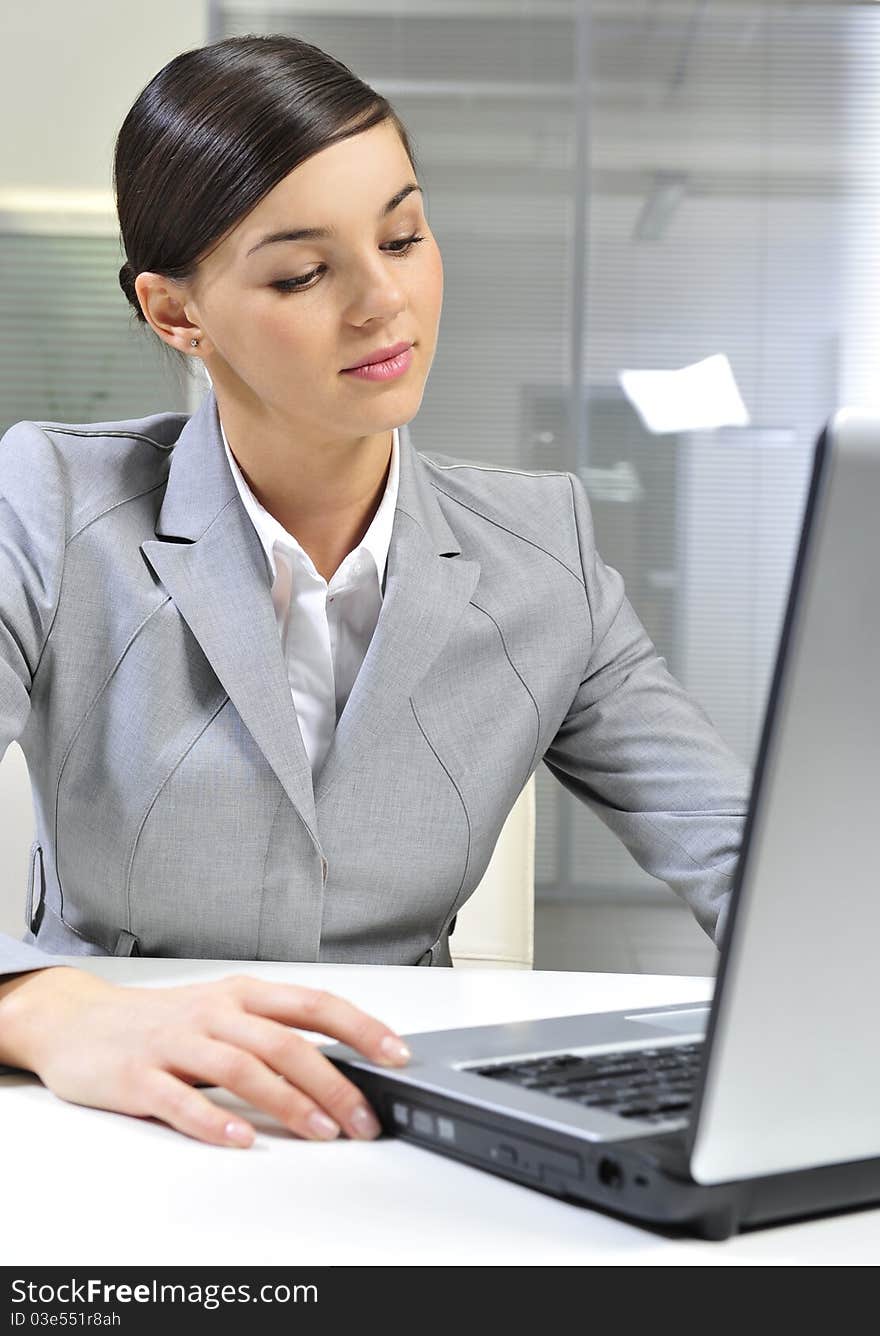 Business woman working in office with laptop