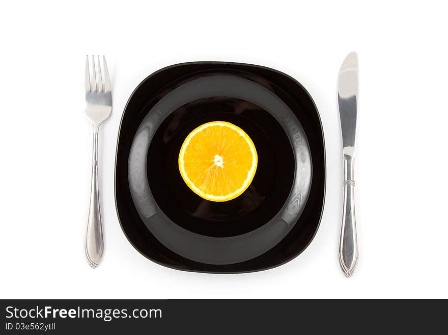 Orange slice served on black plate. Orange slice served on black plate