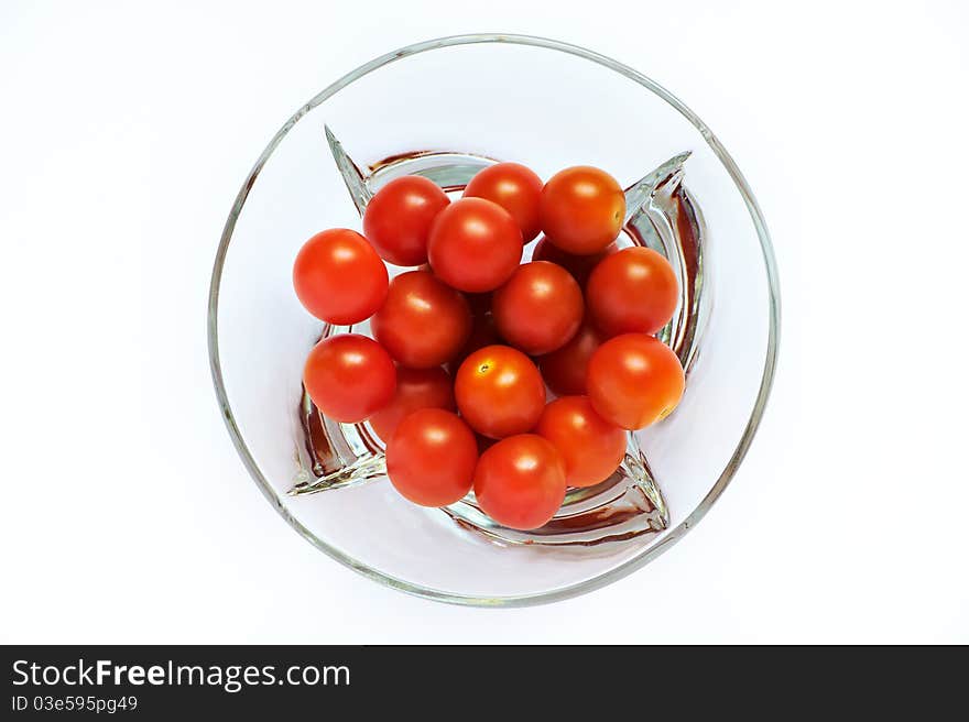 Red tomatoes in a transparent plate