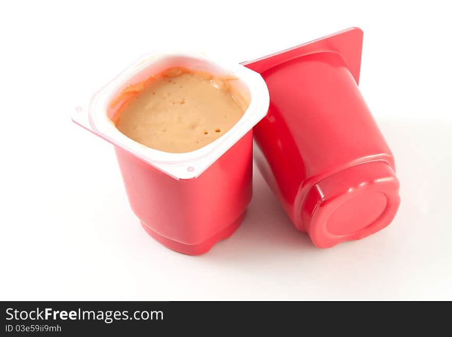 Red plastic yogurt cans isolated on white