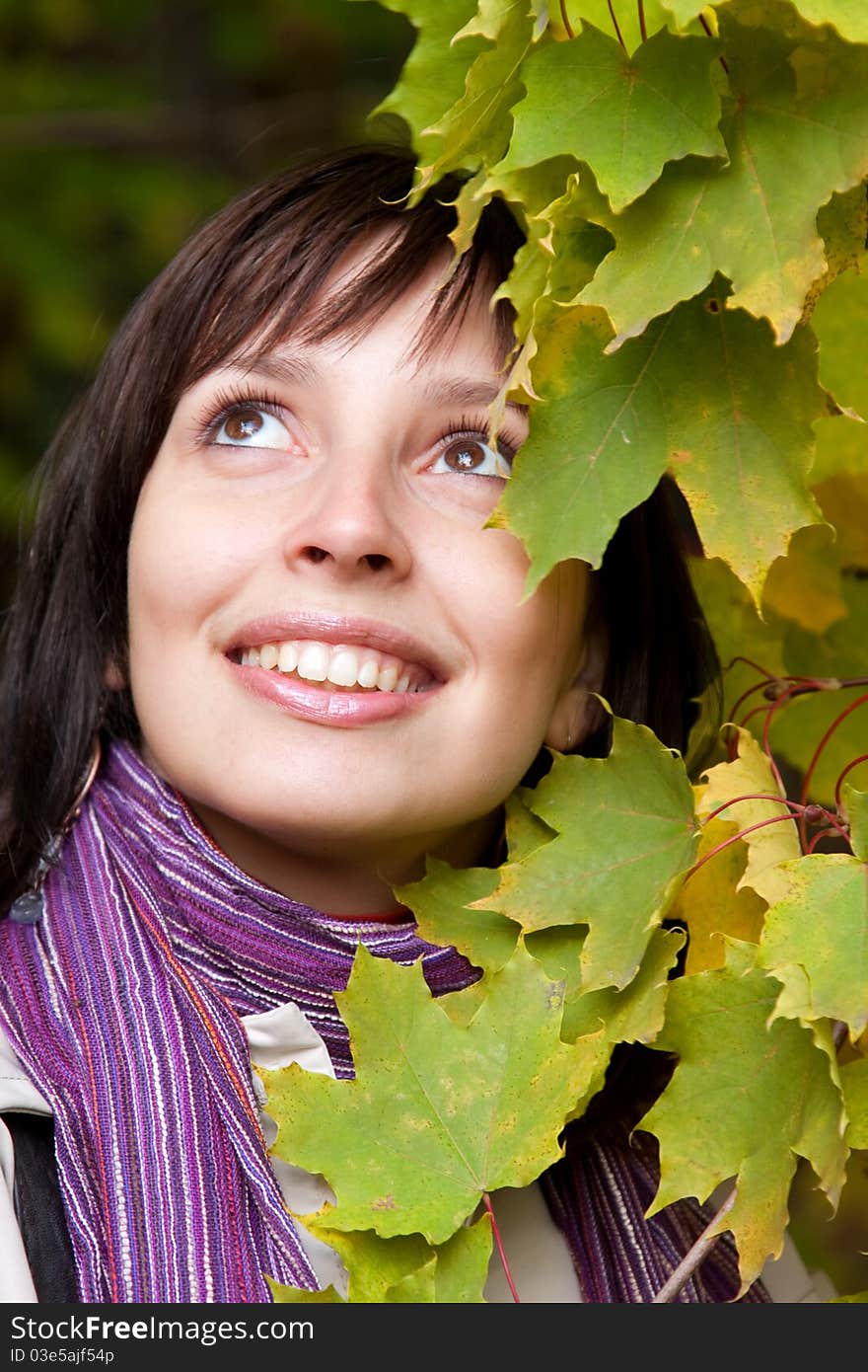 Young pretty woman smiling in fall forest. Young pretty woman smiling in fall forest