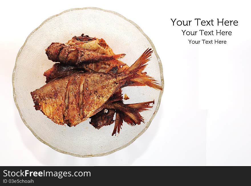 A picture of a bowl of fried fish on white background