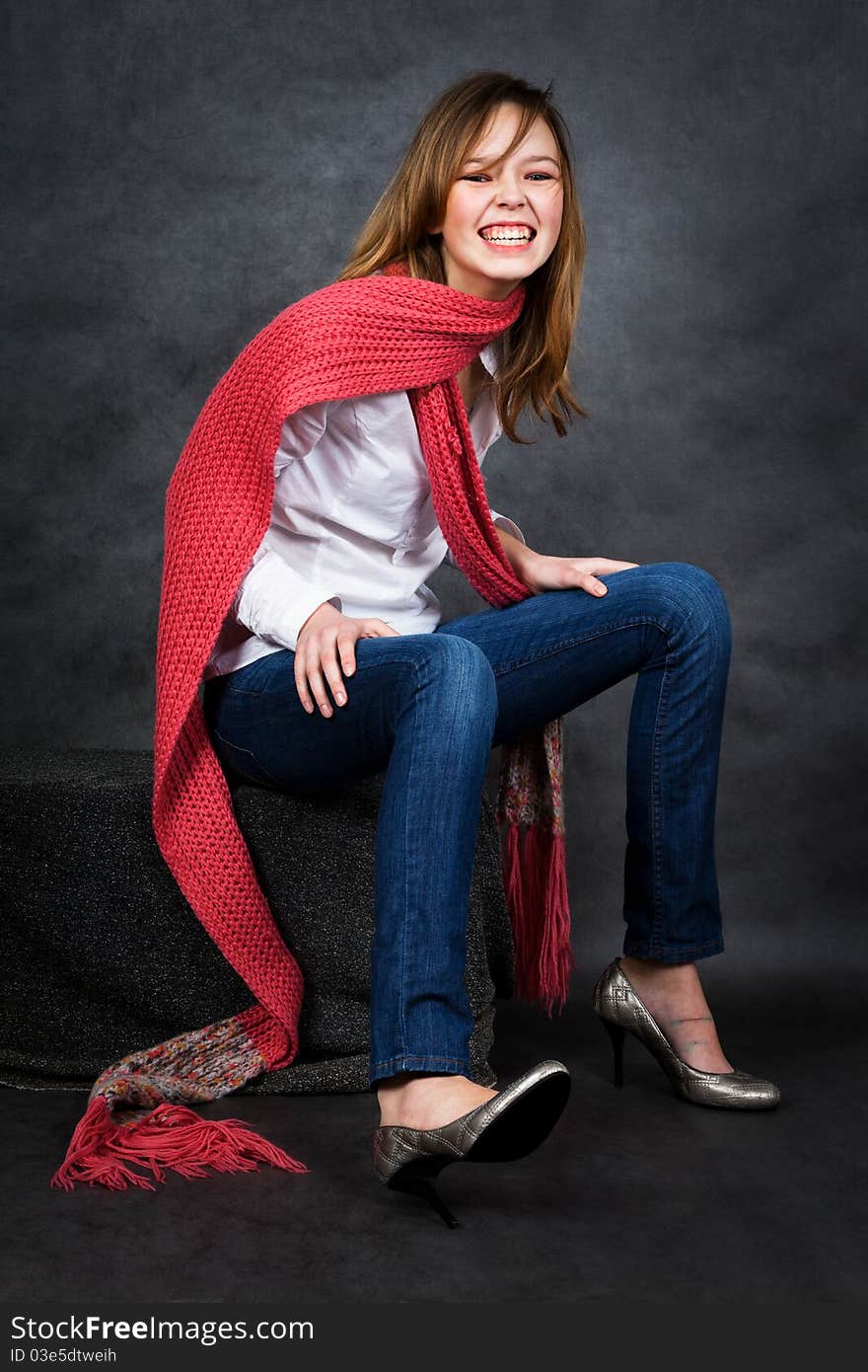 Laughing young girl with long red scarf